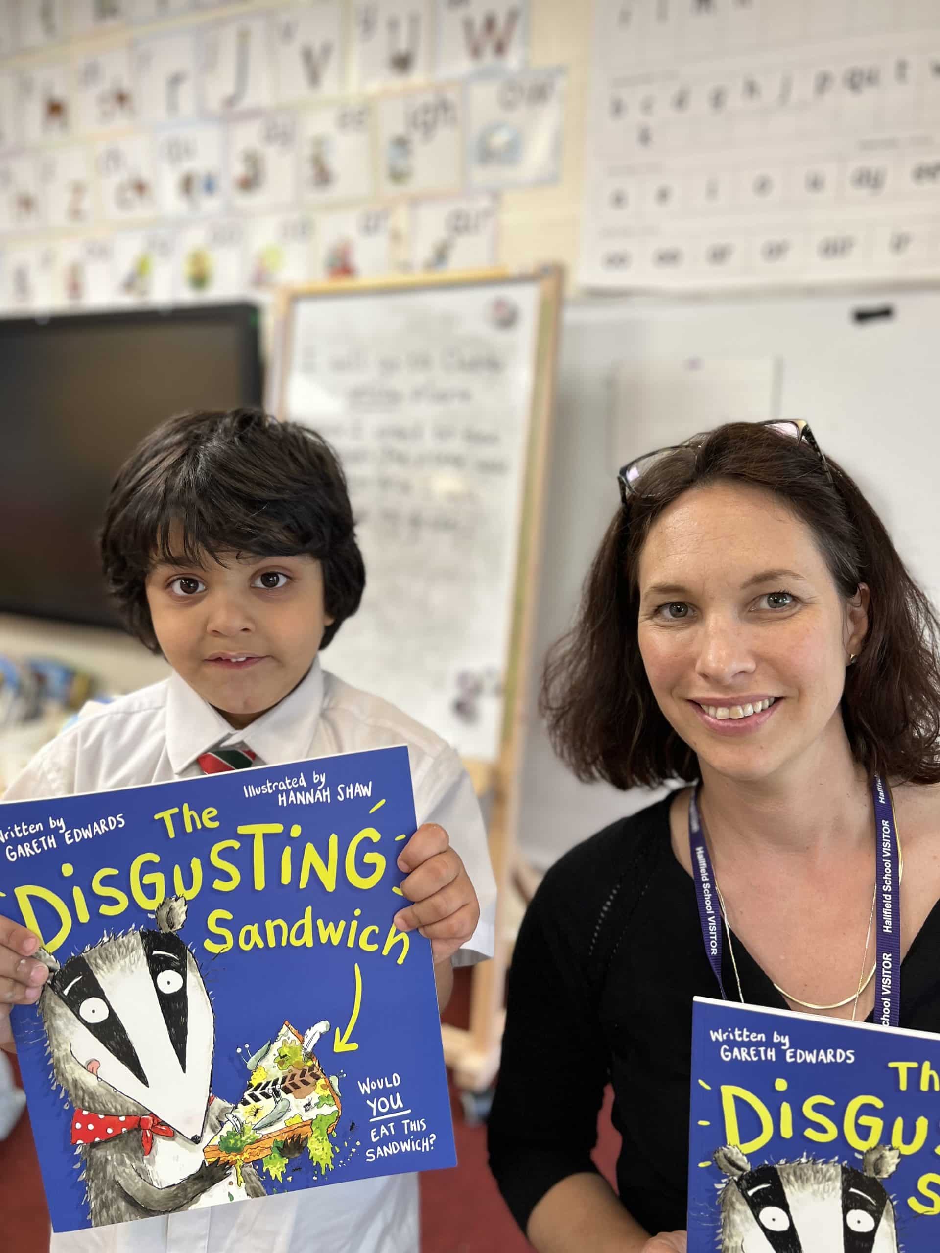 Reception pupil with Hannah Shaw getting his book signed